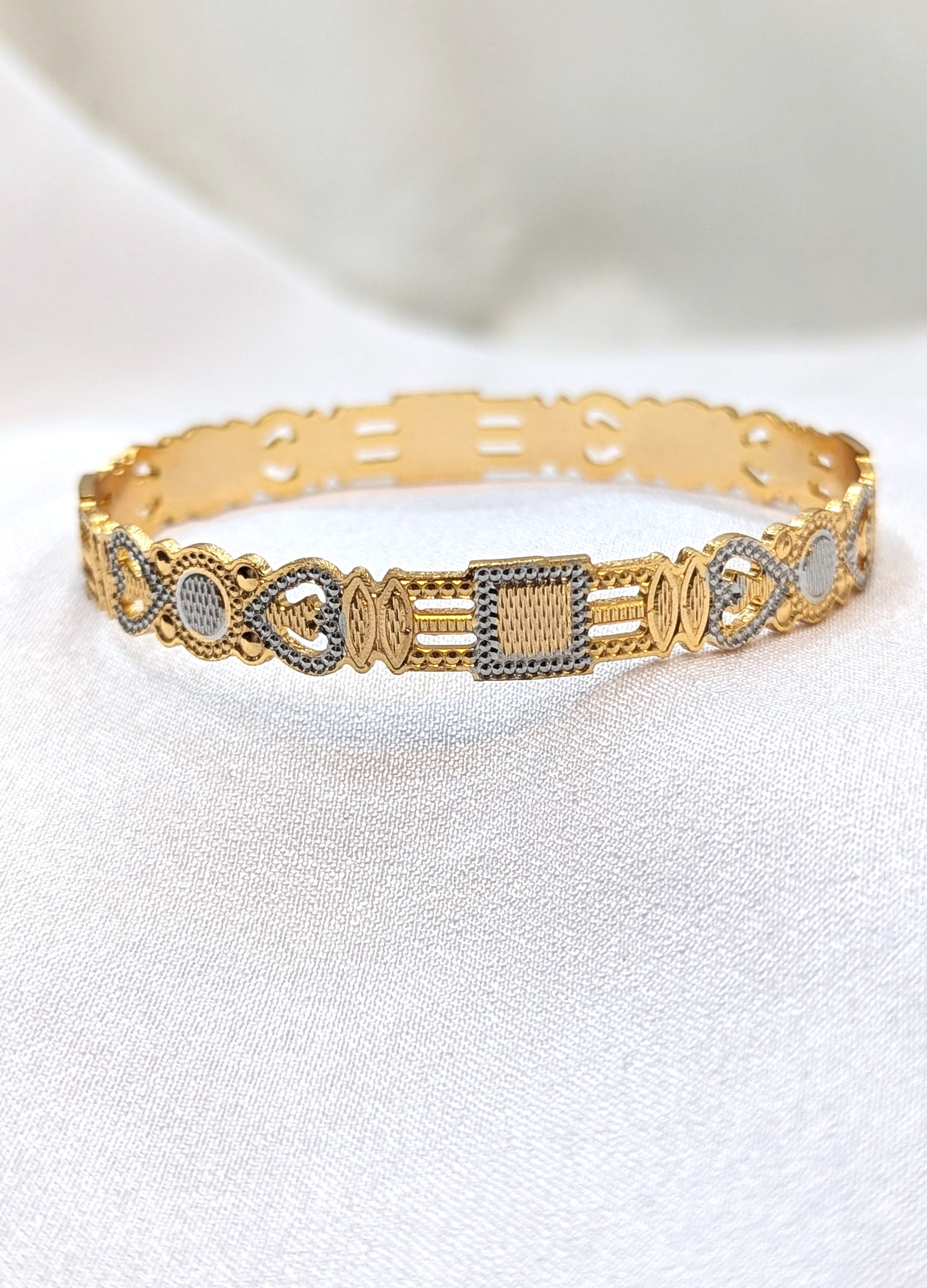 Gold and silver bracelet on a white background