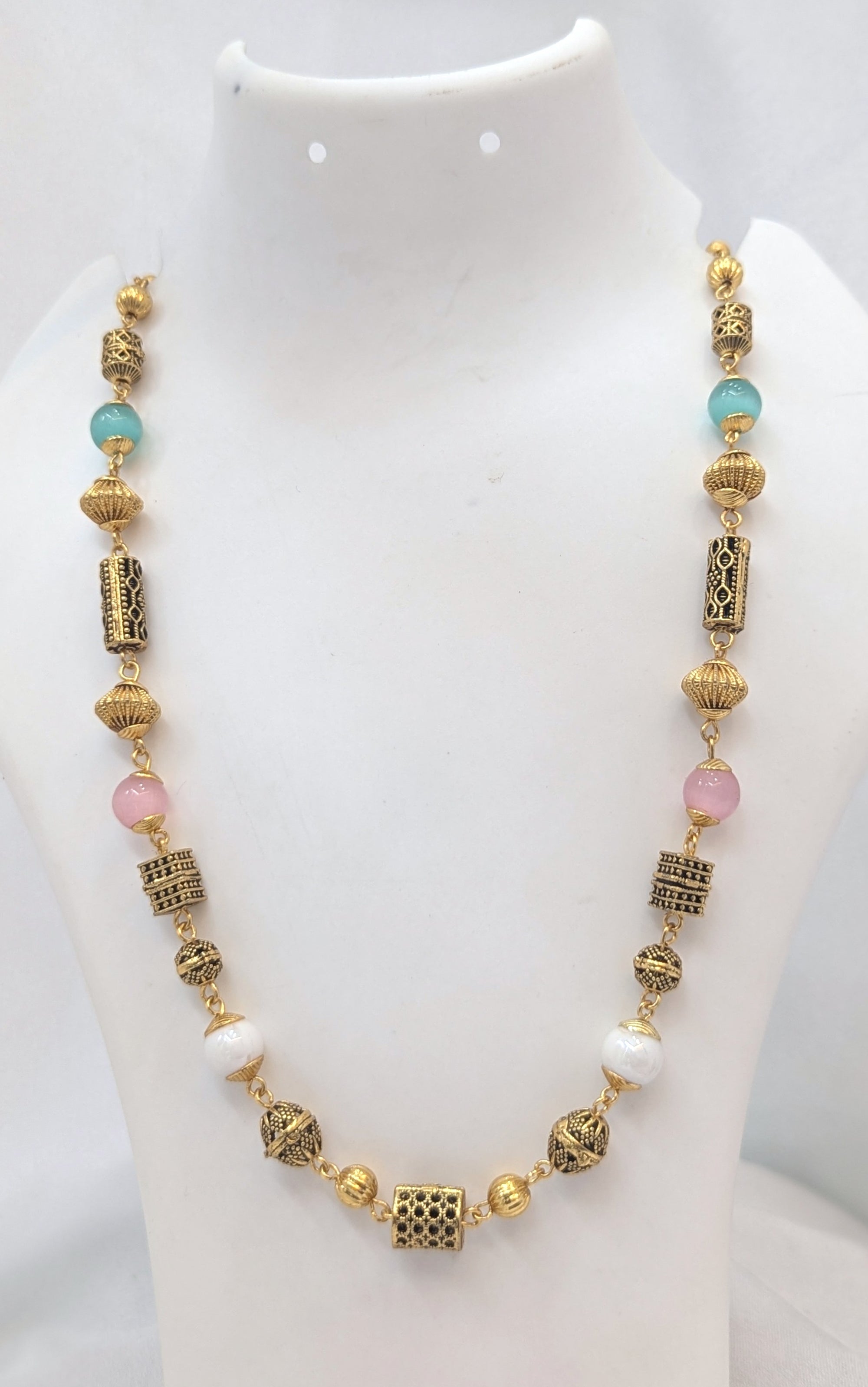 Necklace with gold and multicolored beads on a white background